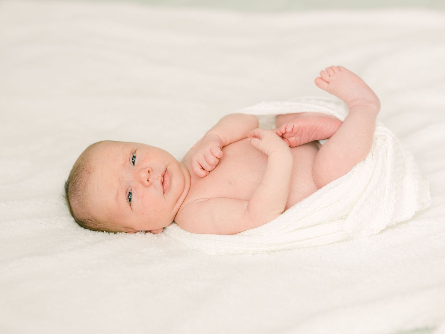 eyes open newborn in-home Salt Lake City utah on bed at home baby Michelle Deppe Photography