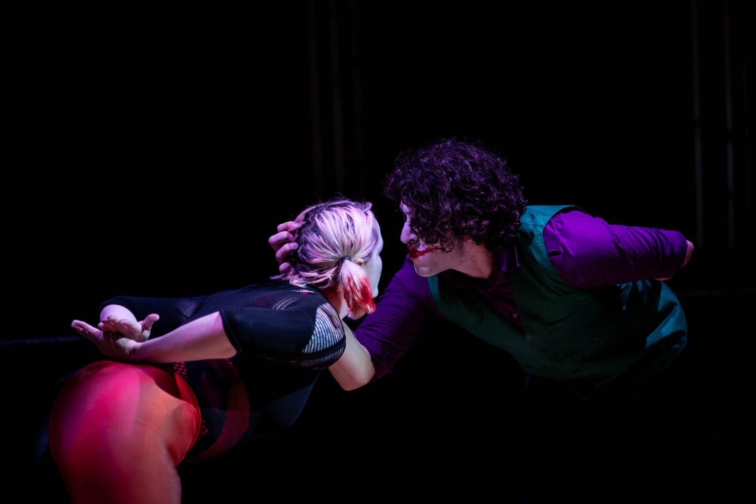 event photography of circus performers on stage dressed as the joker and harlequin