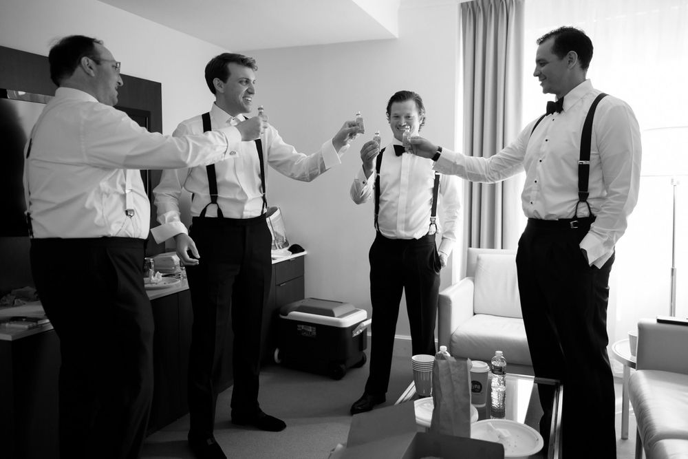 Groomsmen toast groom before wedding at InterContinental Cleveland photographed by Tom Forrest.