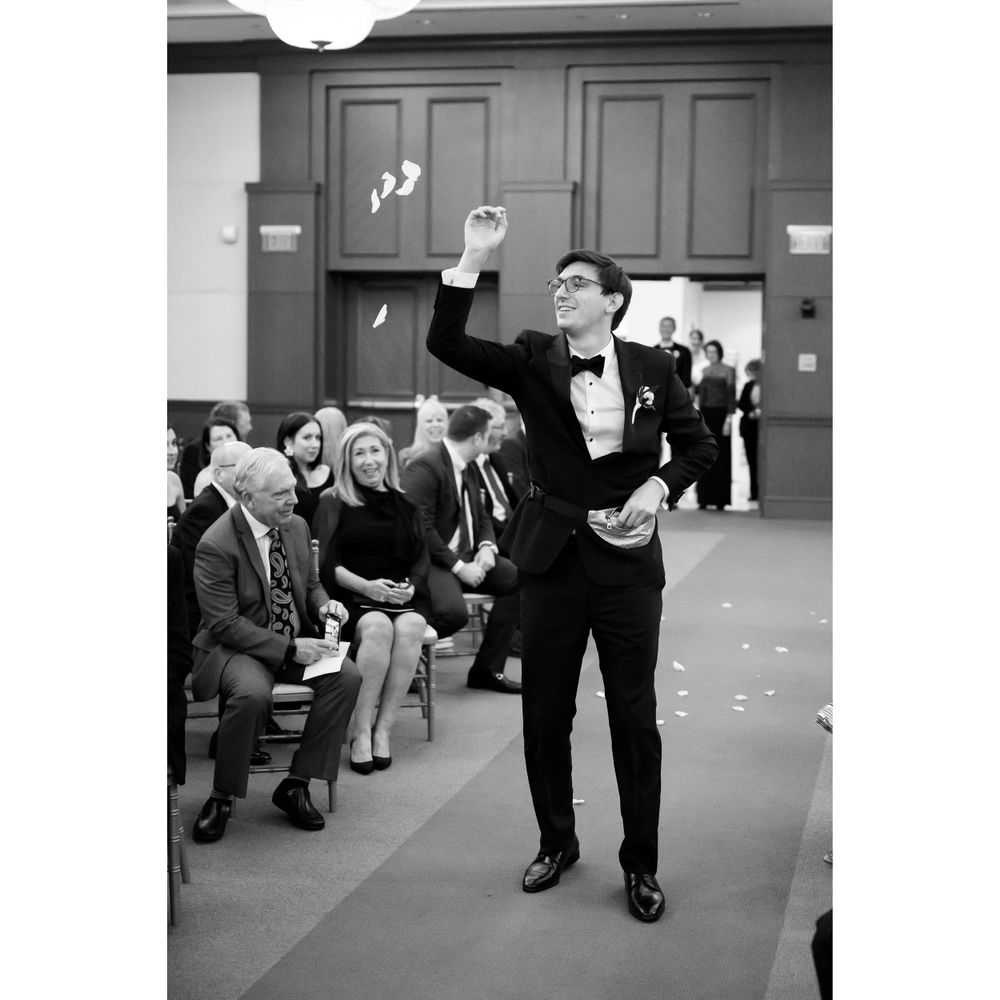 Funny groomsman during wedding ceremony at InterContinental Cleveland photographed by Tom Forrest.