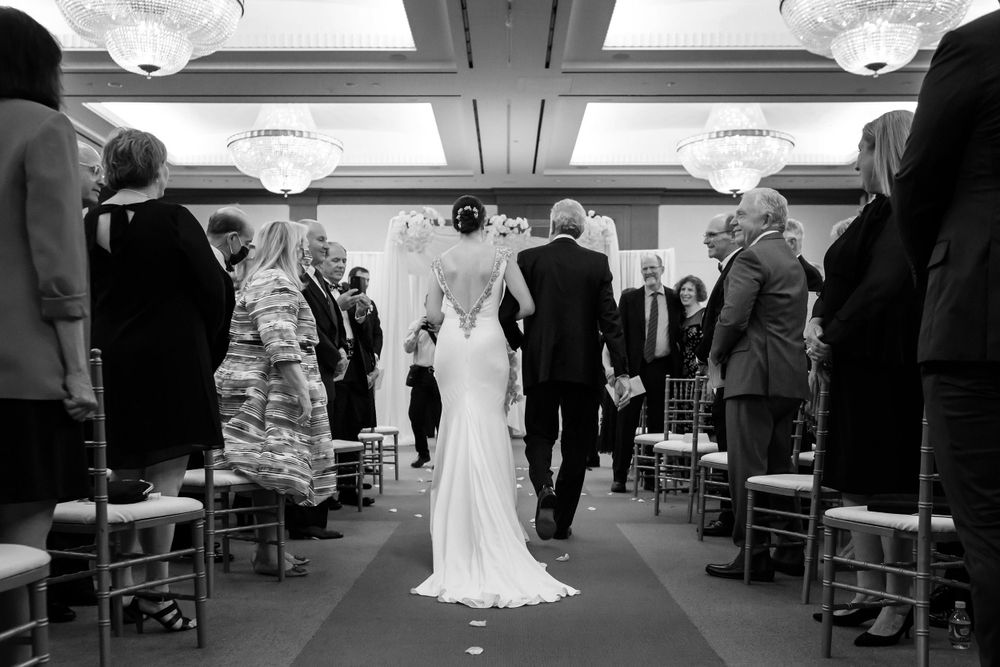 Bride walks down aisle with father during wedding ceremony at InterContinental Cleveland photographed by Tom Forrest.