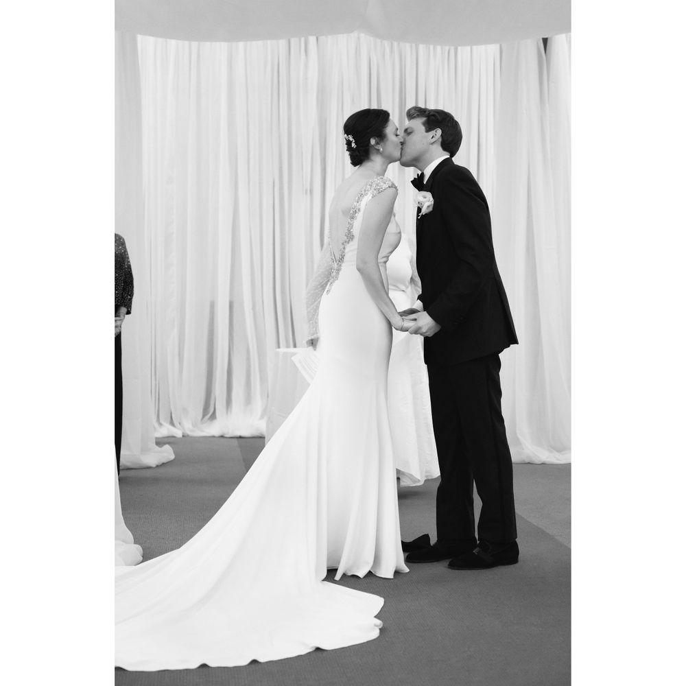 Bride and groom kiss during wedding ceremony at InterContinental Cleveland photographed by Tom Forrest.