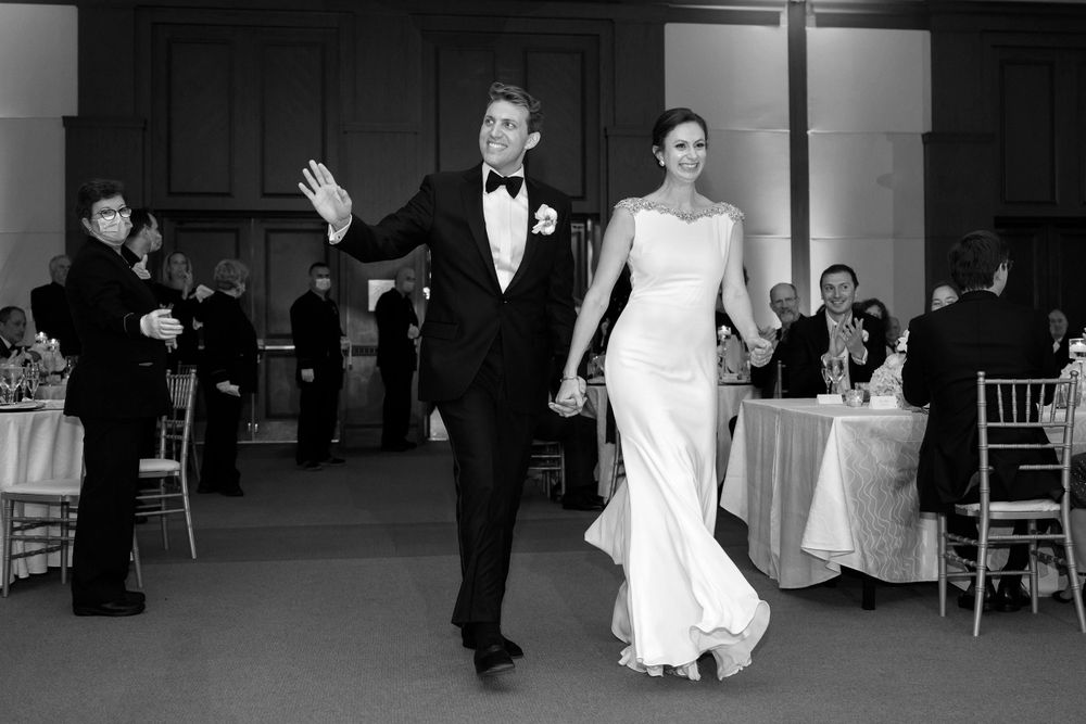 Bride and groom enter wedding reception at InterContinental Cleveland photographed by Tom Forrest.