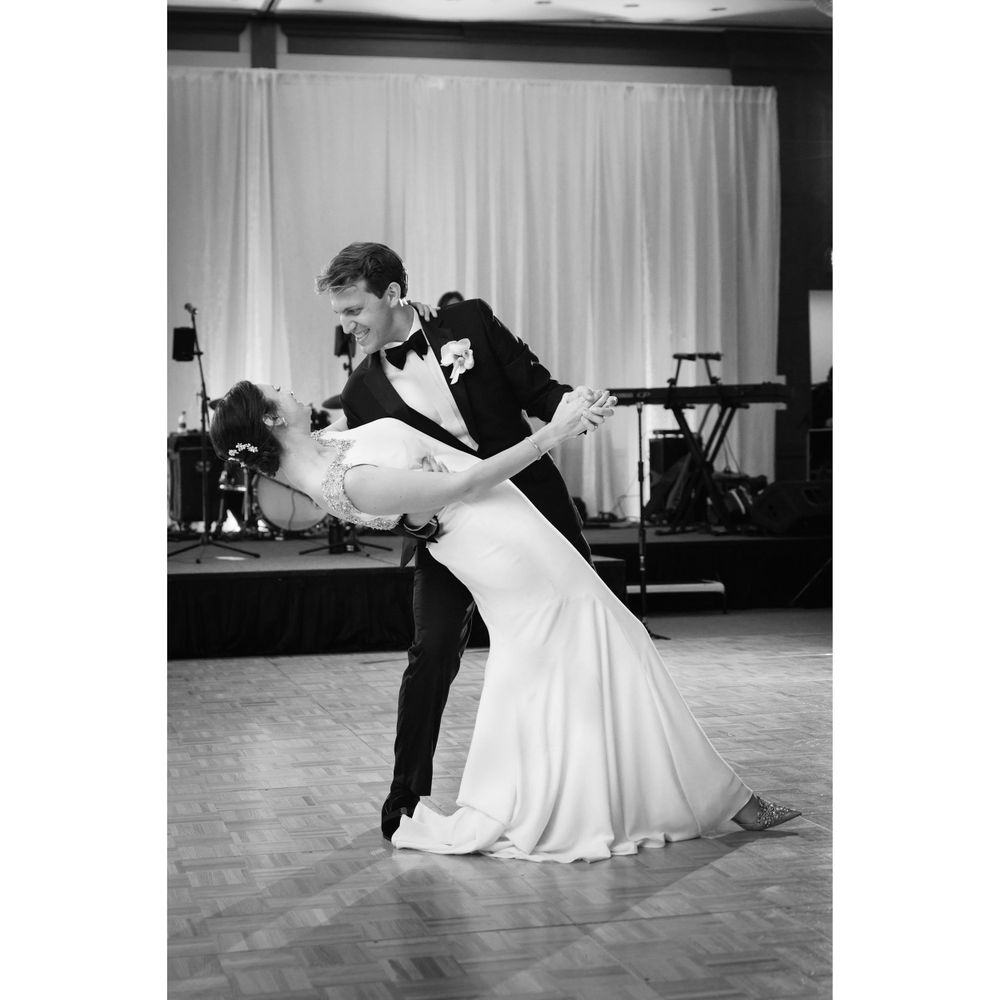Grooms dips bride on dance floor during wedding reception at InterContinental Cleveland photographed by Tom Forrest.