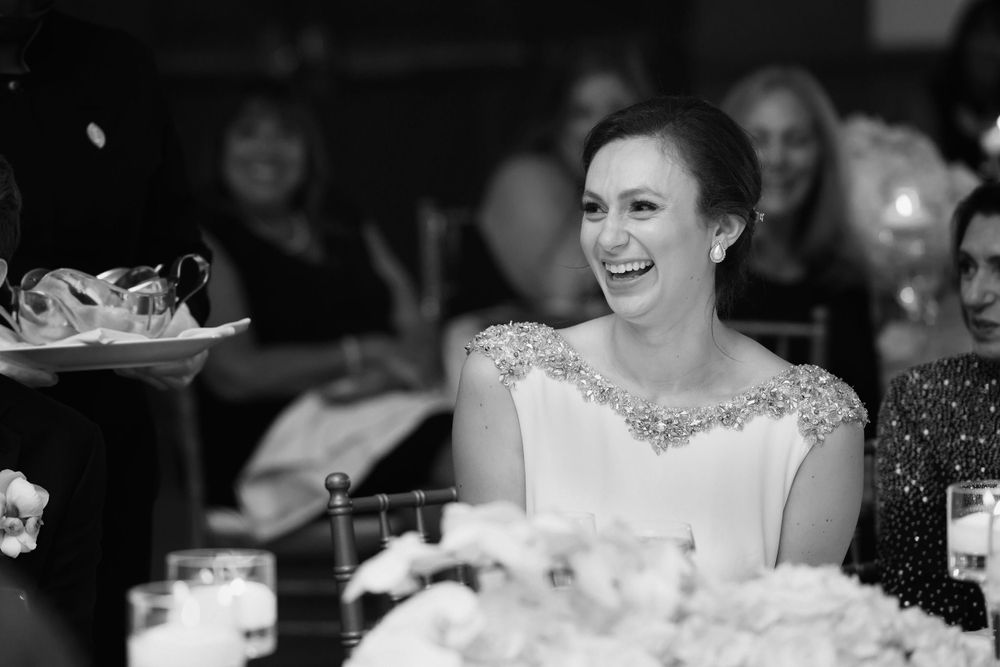 Bride reacts to heartfelt speech during wedding reception at InterContinental Cleveland photographed by Tom Forrest.