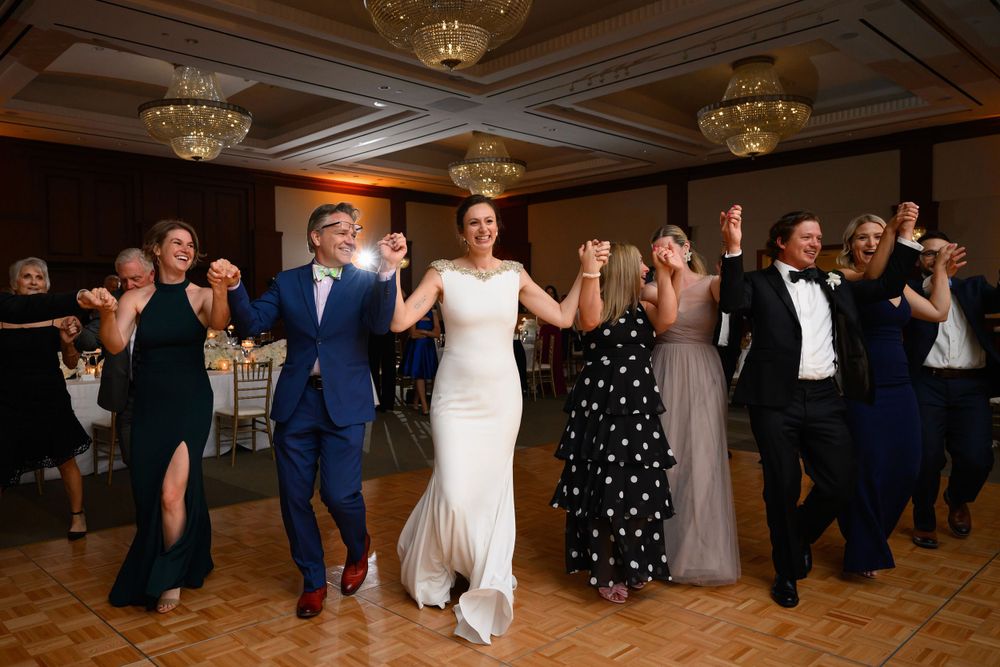 Bride and guests join dance floor during wedding reception at InterContinental Cleveland photographed by Tom Forrest.