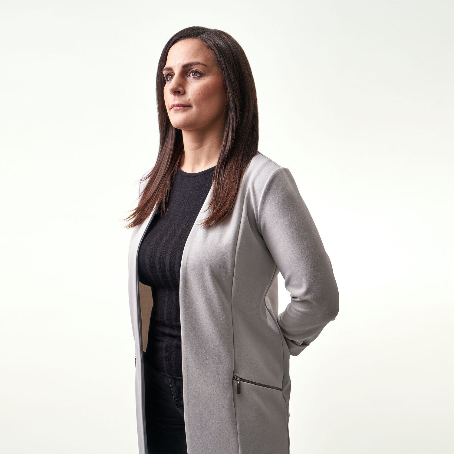 Corporate Headshot Professional Business Portrait of a Researcher wearing a lab coat on a cream coloured background