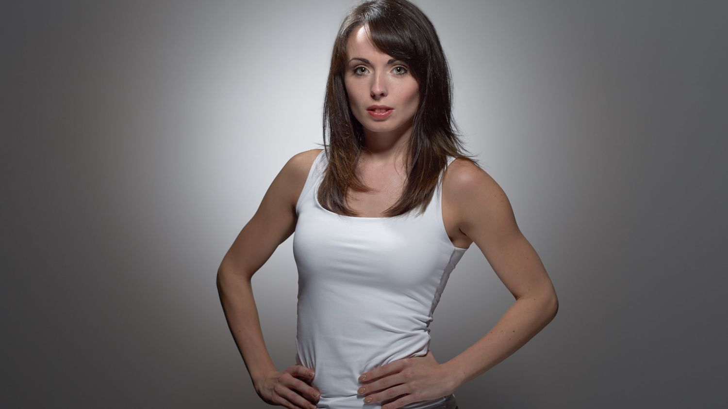 Corporate Headshot Professional Business Portrait of a dance teacher dark hair wearing a white tee on a grey backdrop