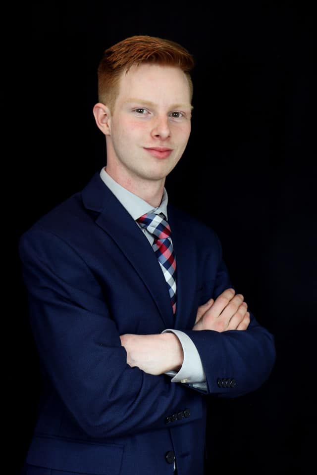 Professional school photos showing poses in navy blue uniform and striped tie against dark background.