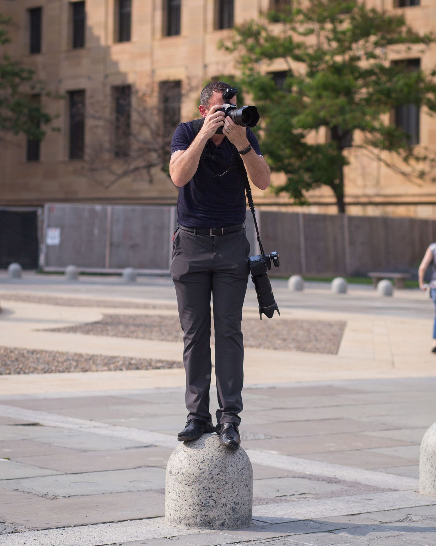 wedding photographer taking photos on the steps of the Philadelphia Art Museum  steps