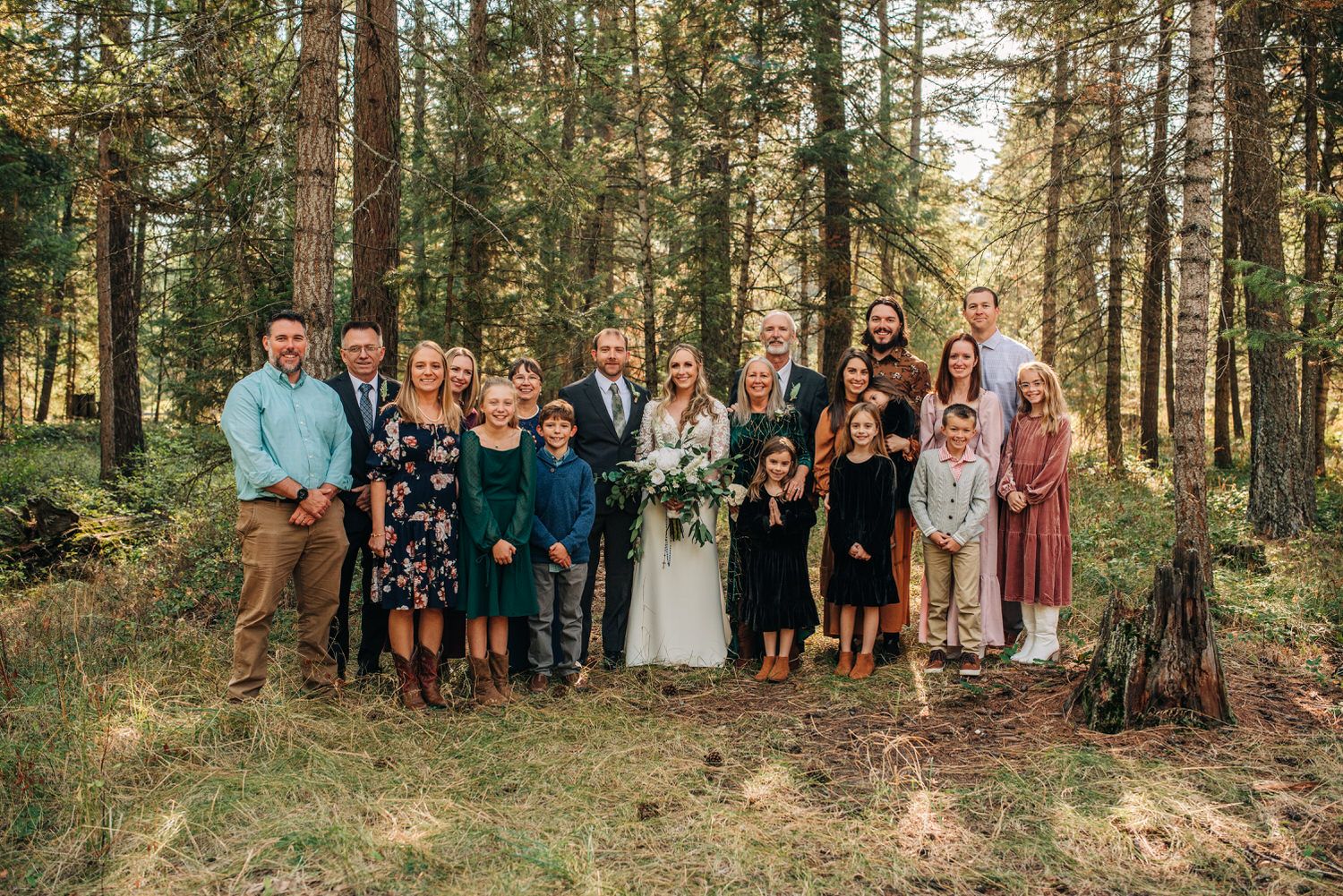 Married couple taking photo with family in attendance at their elopement
