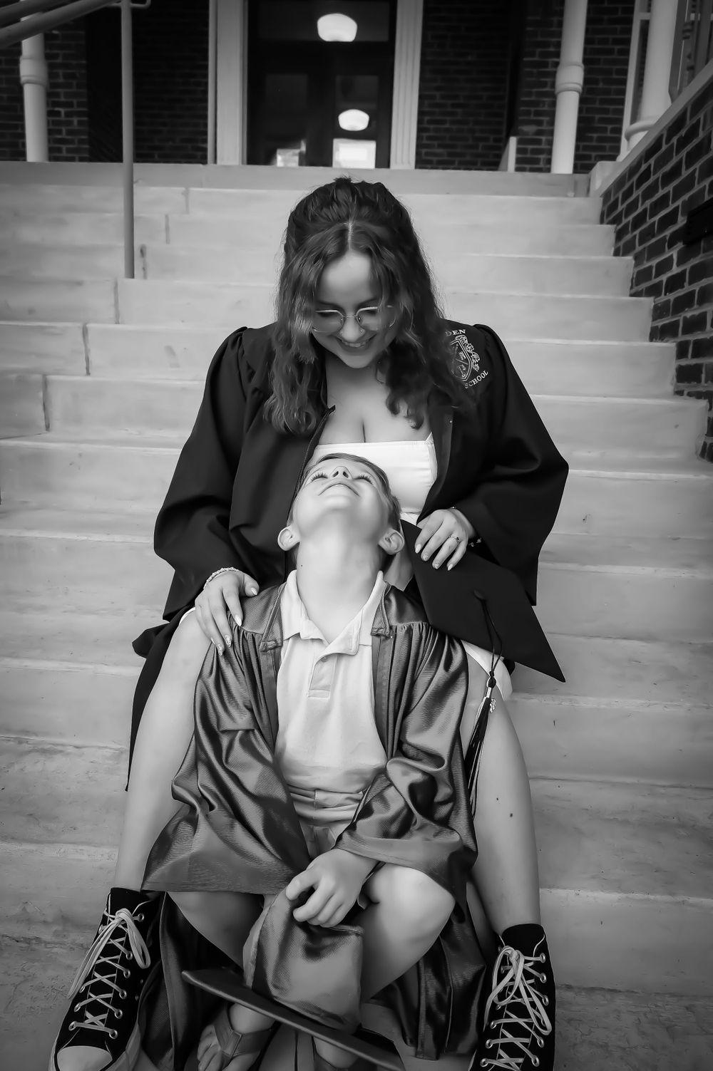 Black and white photo series showing playful laughter and joy on steps.