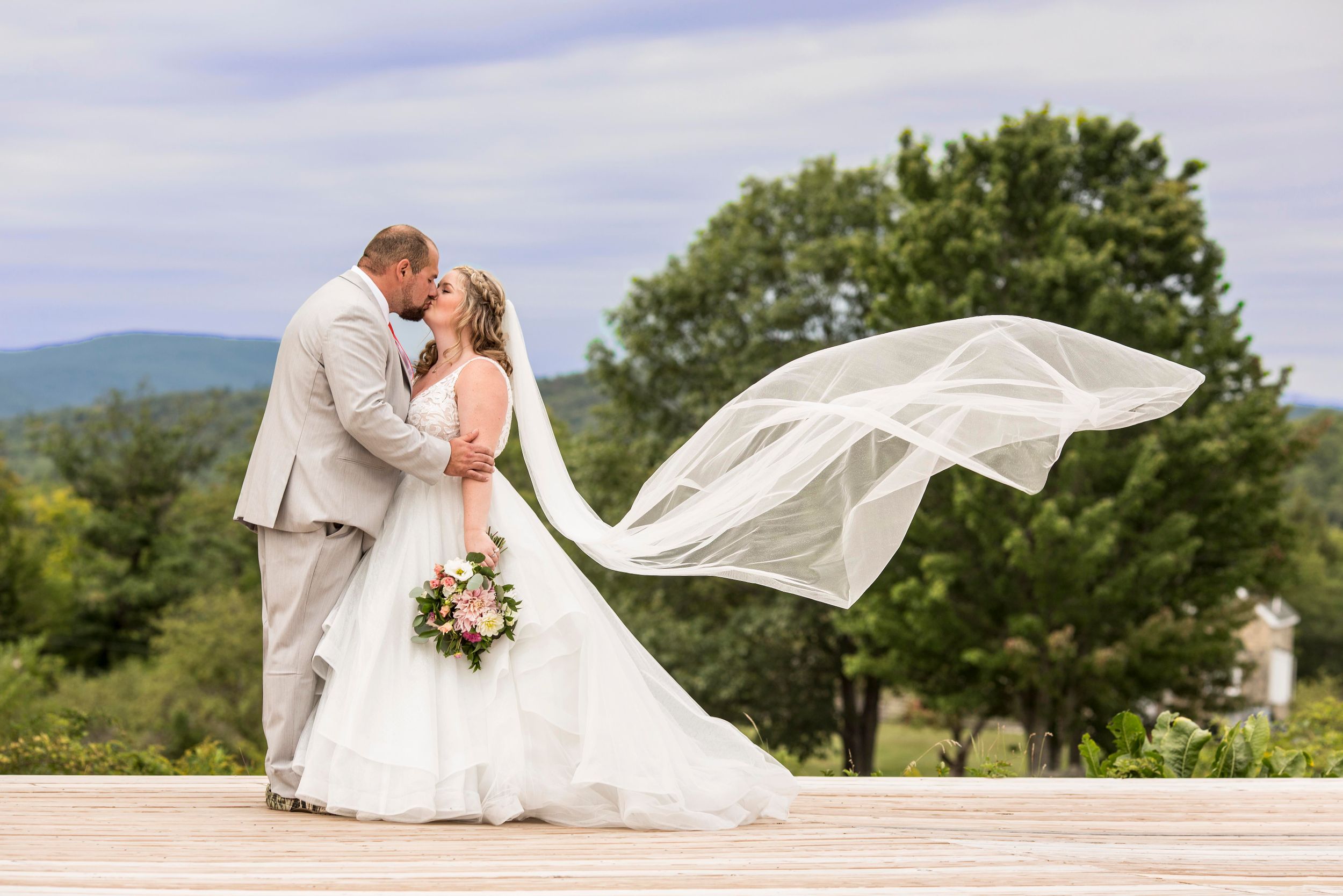 Bride and groom portraits overlooking the mountains in Maine