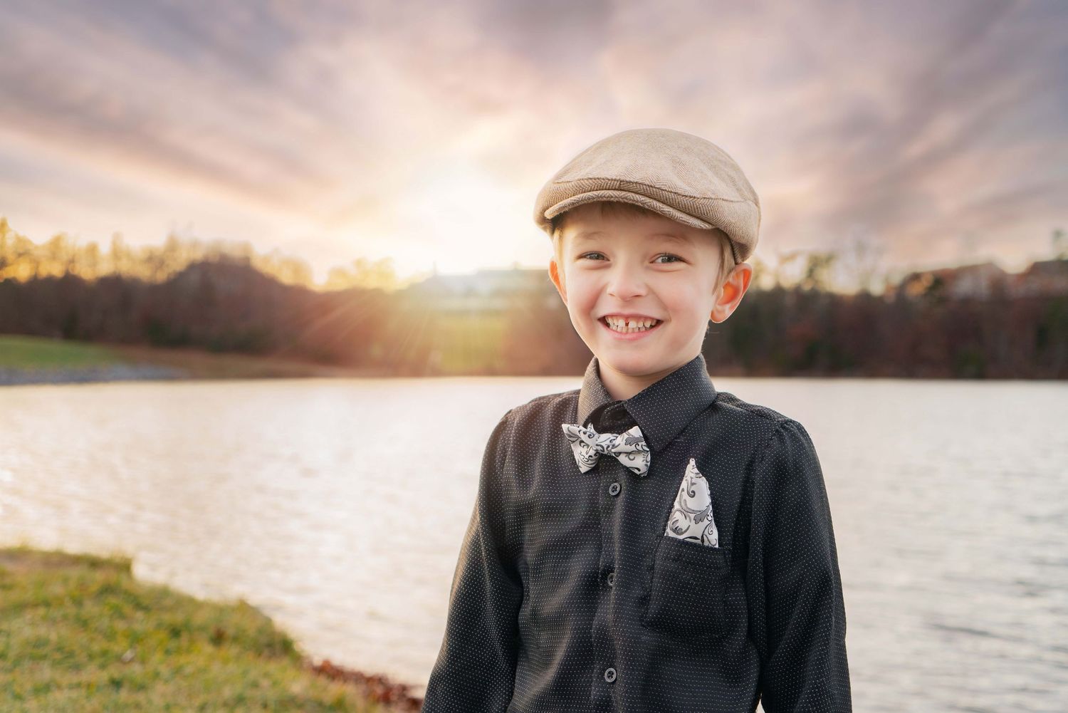 Boy smiles in portrait by Lake Frederick in Frederick County, VA