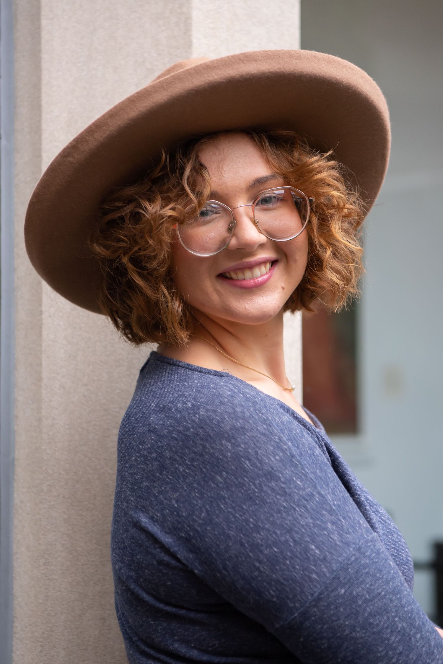 senior girl wearing brown hat with blue dress
