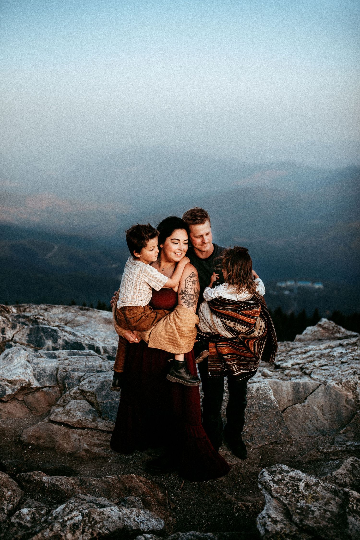 Family photo as they keep warm with the view from Mt. Spokane, in Washington.