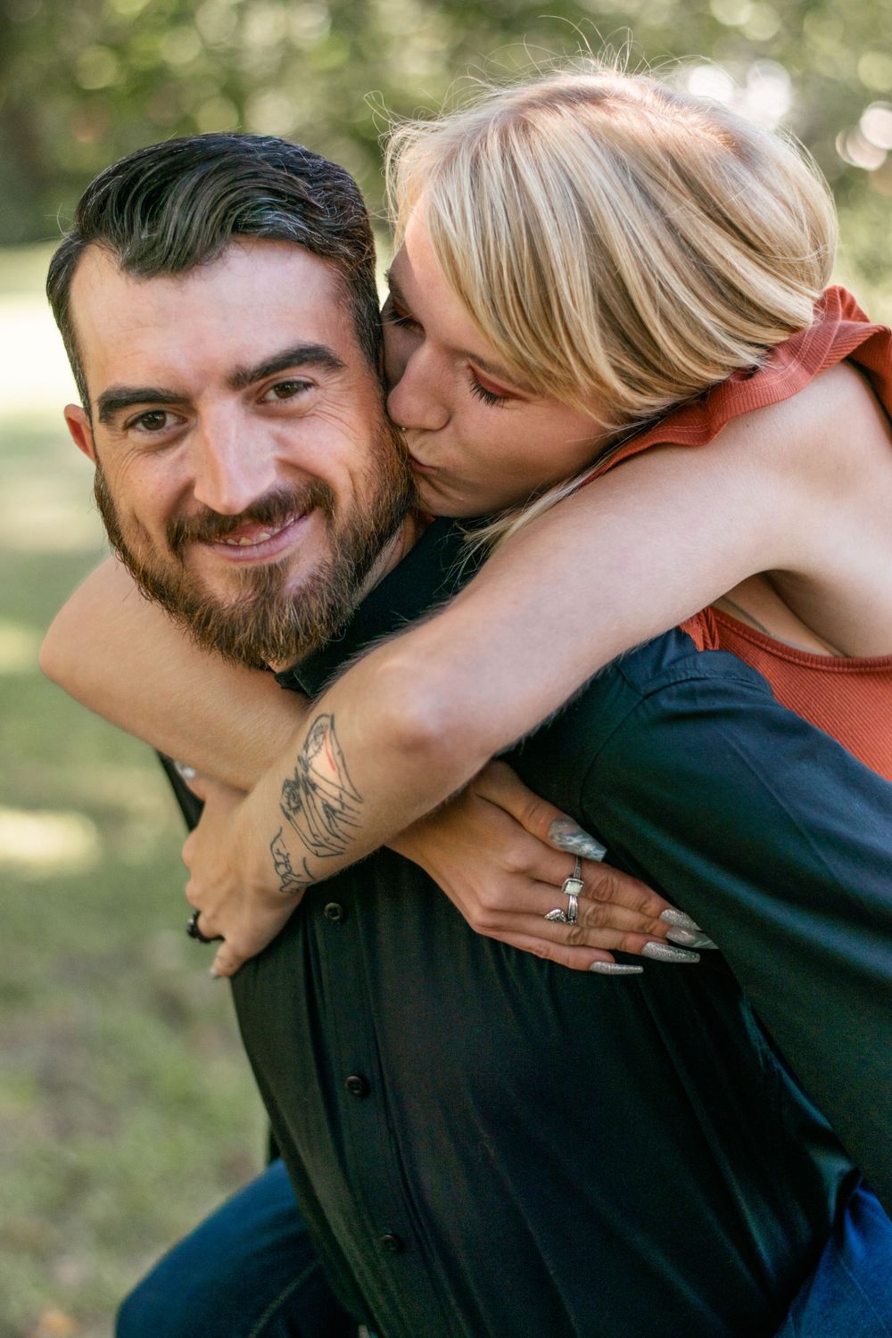 A playful piggyback moment captured outdoors in natural lighting.