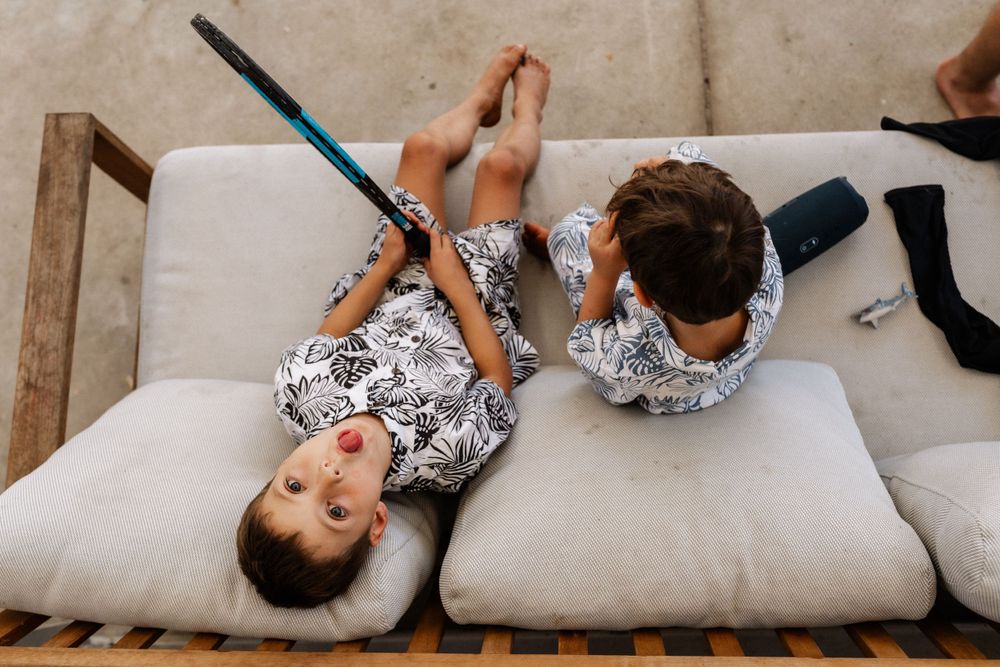 Two cousins on the couch together during an extended family photo session in Perth