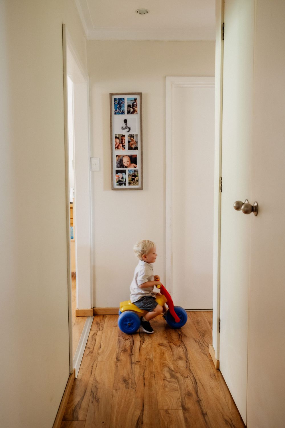 A toddler riding a trike in their home in Perth