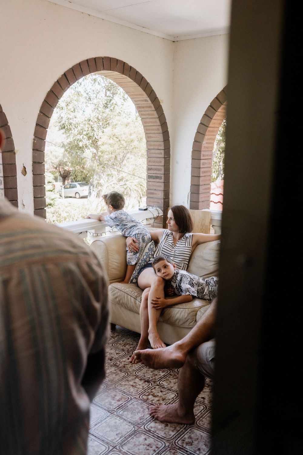 A mother and her son on the couch during an extended family photo session