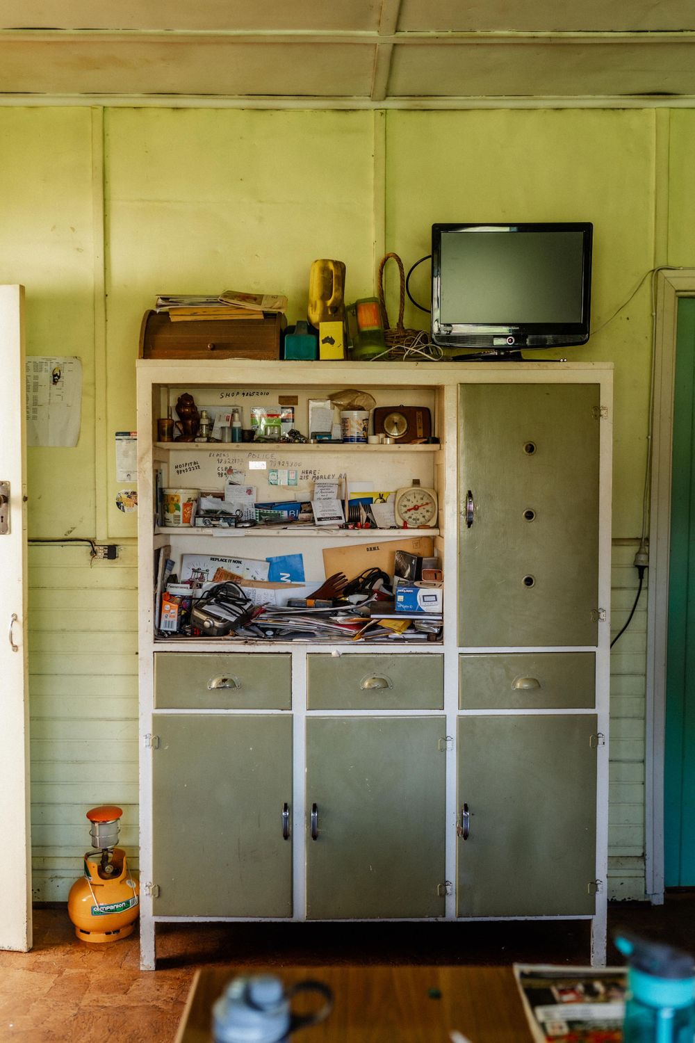 An old kitchen cabinet packed full of the things of life