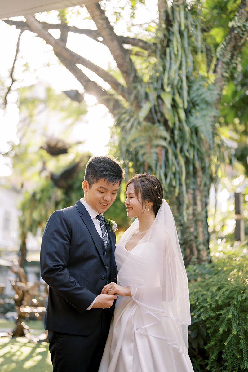 A series of tender moments between a couple in wedding attire surrounded by lush greenery.