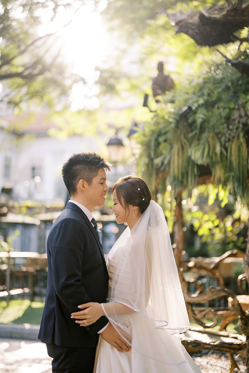 Romantic garden wedding photos with soft natural lighting and tropical foliage.