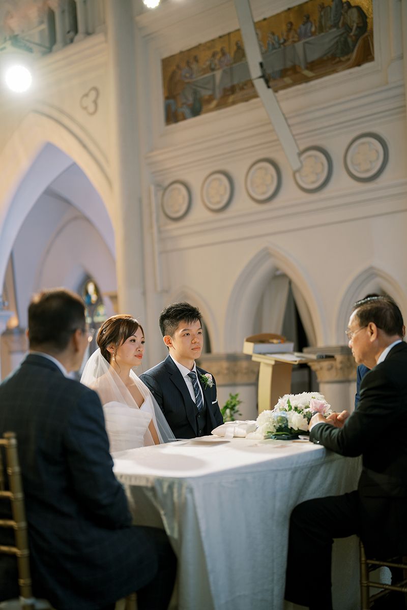 Wedding reception in a grand hall with arched architecture and classical wall murals.