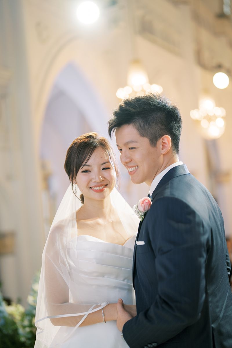 Romantic wedding moment captured in a beautifully lit classical venue.