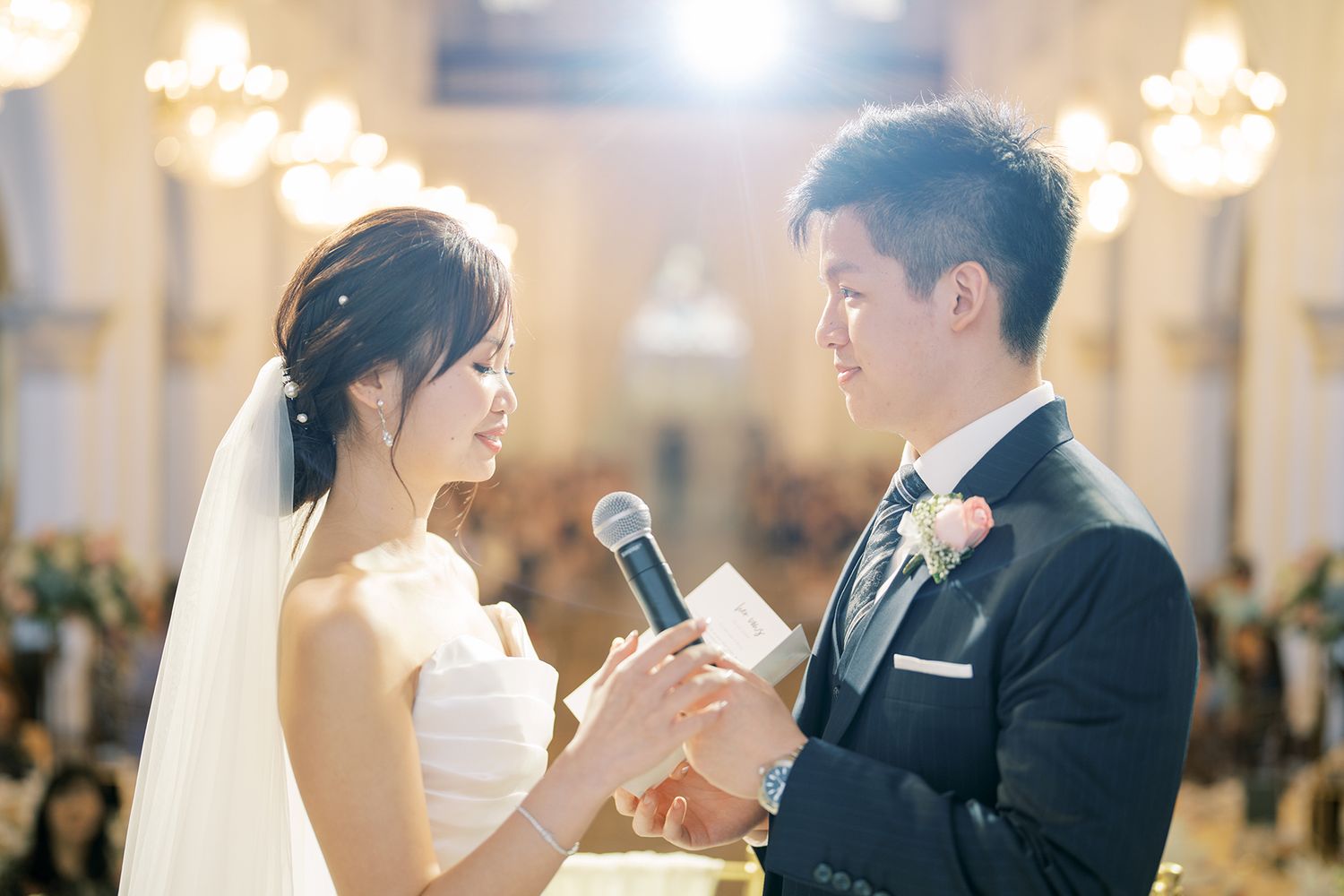 Wedding ceremony moment captured in a historic church with dramatic lighting and architectural details.