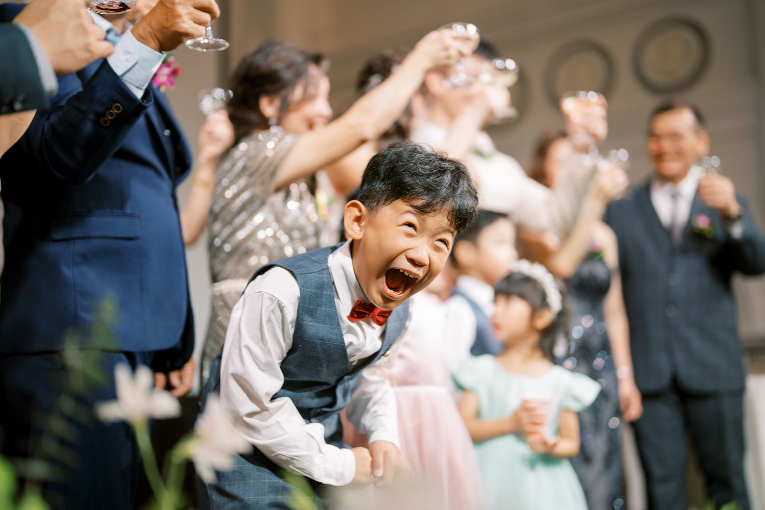 Wedding guests dancing and celebrating at an elegant indoor reception.