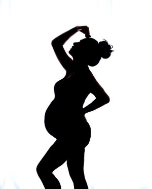 Maternity Shoot, Back Lit black and white silhouette image showing outline of pregnancy and curves of bump