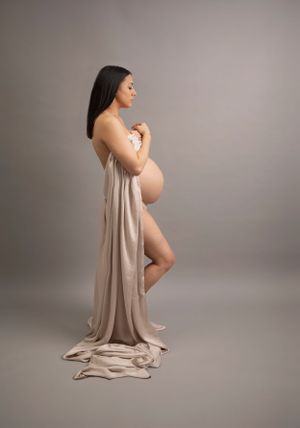 Maternity Photoshoot, Side Pose to show bump, Mum to be elegantly draped in champagne coloured silk throw
