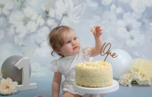 1 Year old Cake smash, Blue & White floral backdrop, wooden No.1 Prop cream white & grey balloons, white chocolate cake