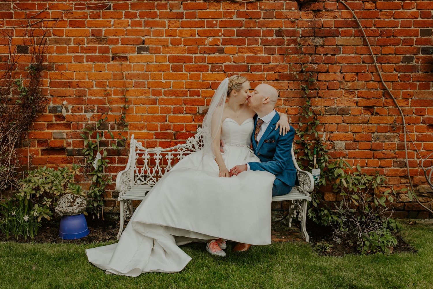 Bride and Groom kissing on bench, Woburn Coffee House Wedding, Buckinghamshire