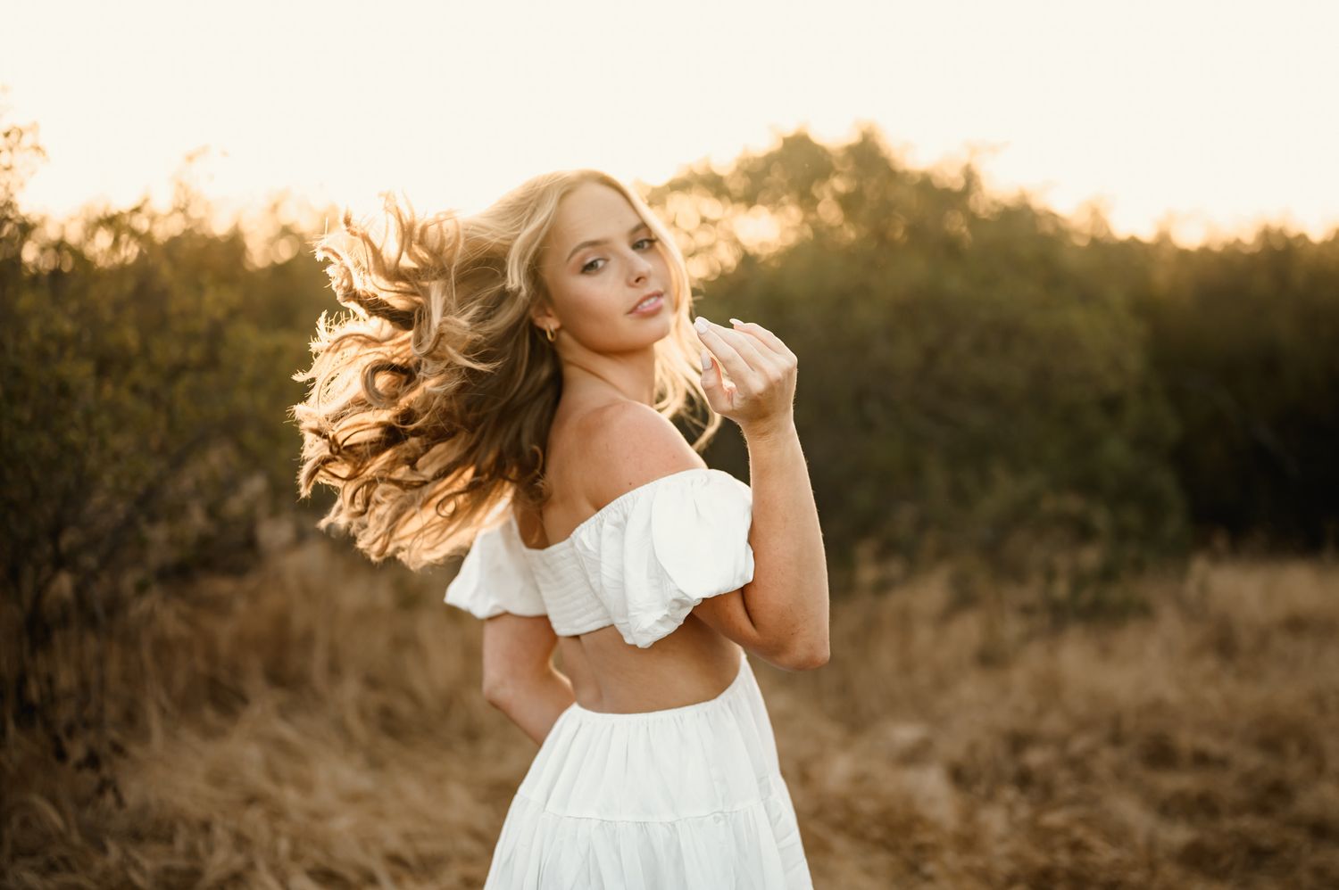 creative senior portrait by Thousand Oaks photographer, of high school senior flipping hair in Ojai