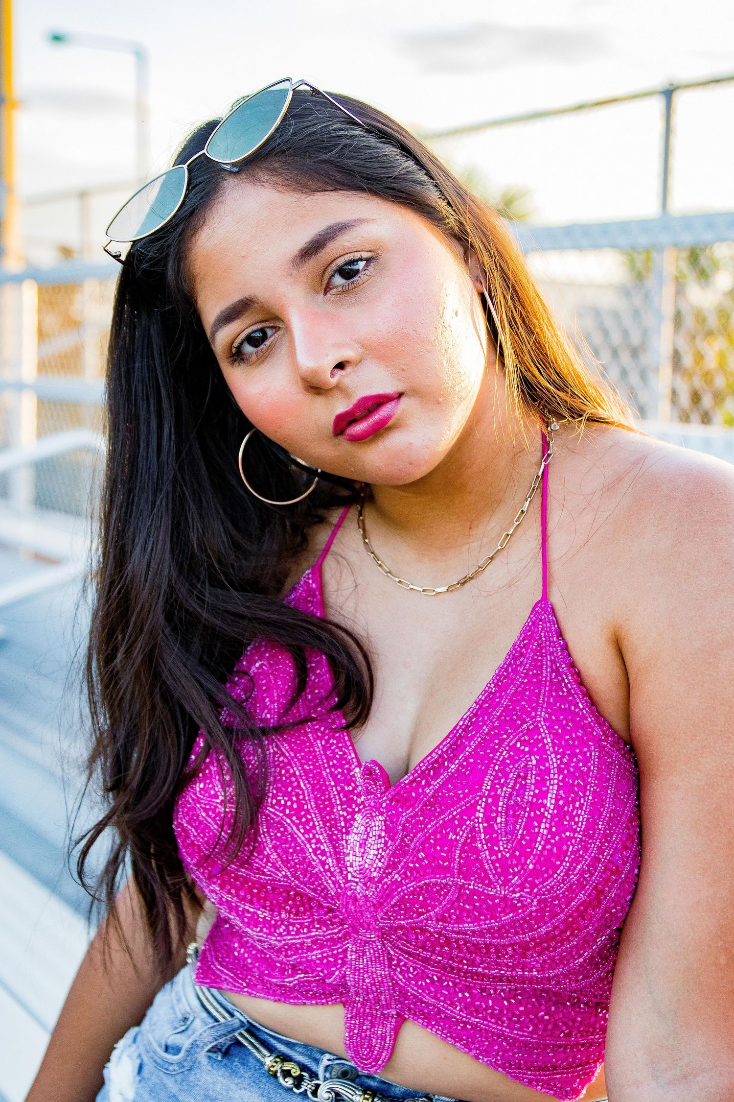 Girl with butterfly sequin top looking at camera