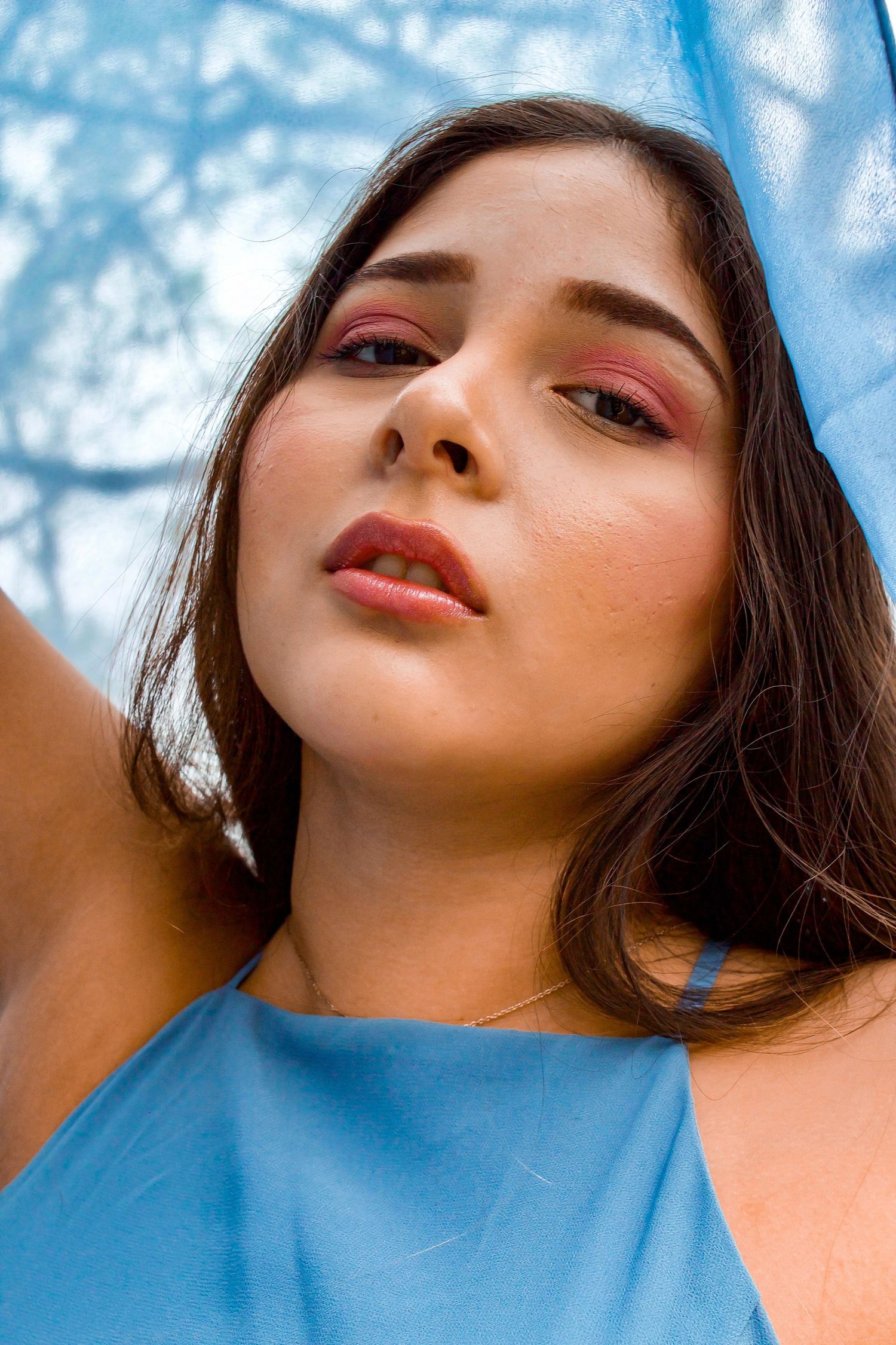 Close-up of girl wearing blue dress with scarf over her head