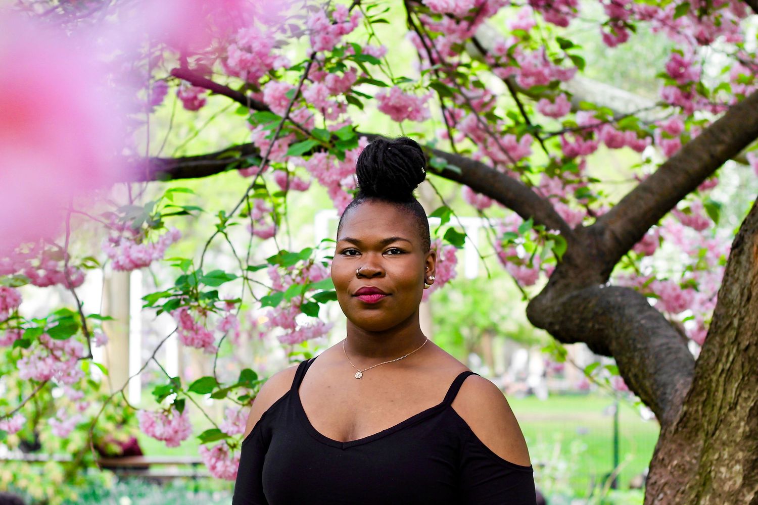Woman surrounded by pink flowers, New York City