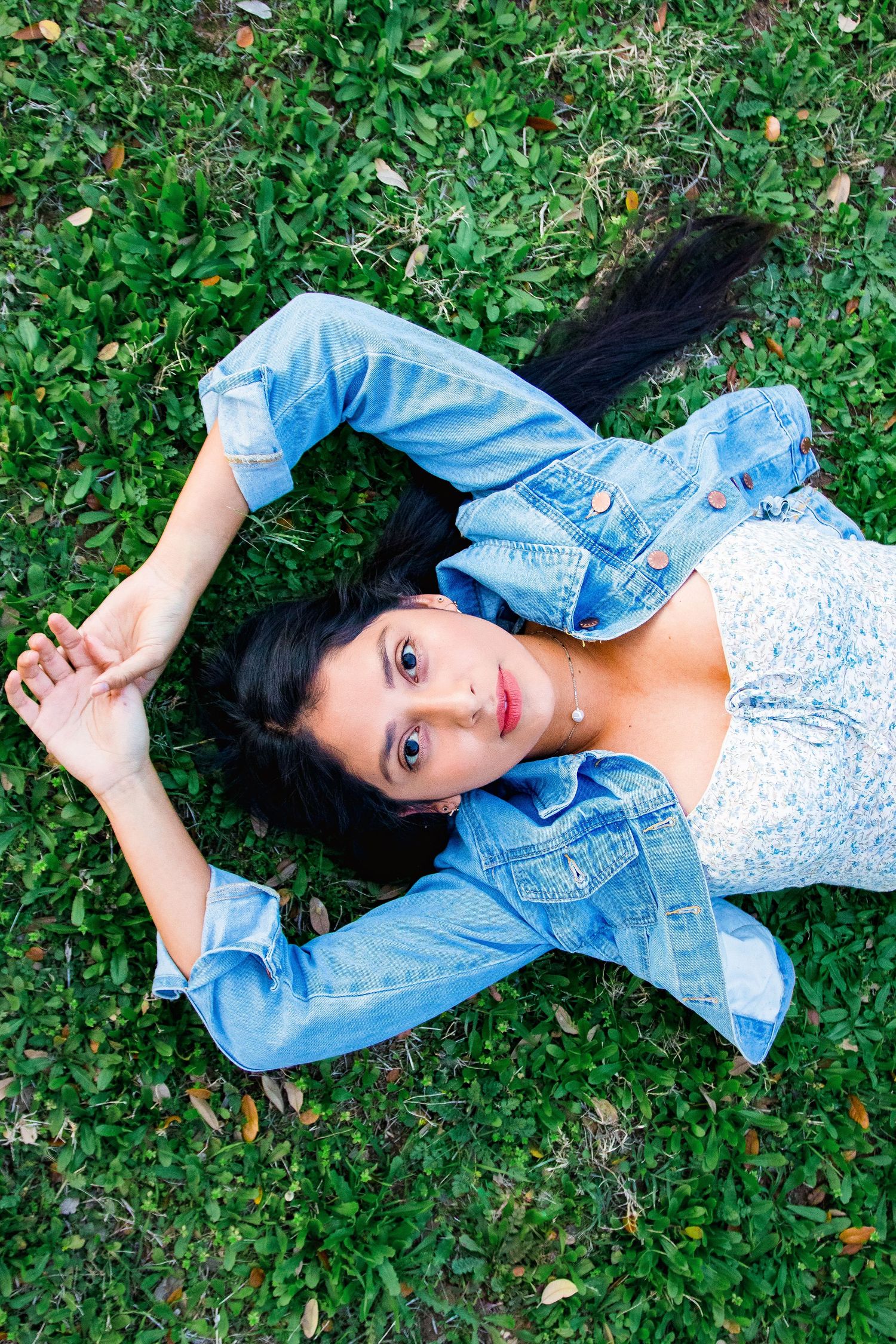 Birds-eye-view, girl in blue jean jacket laying on floor