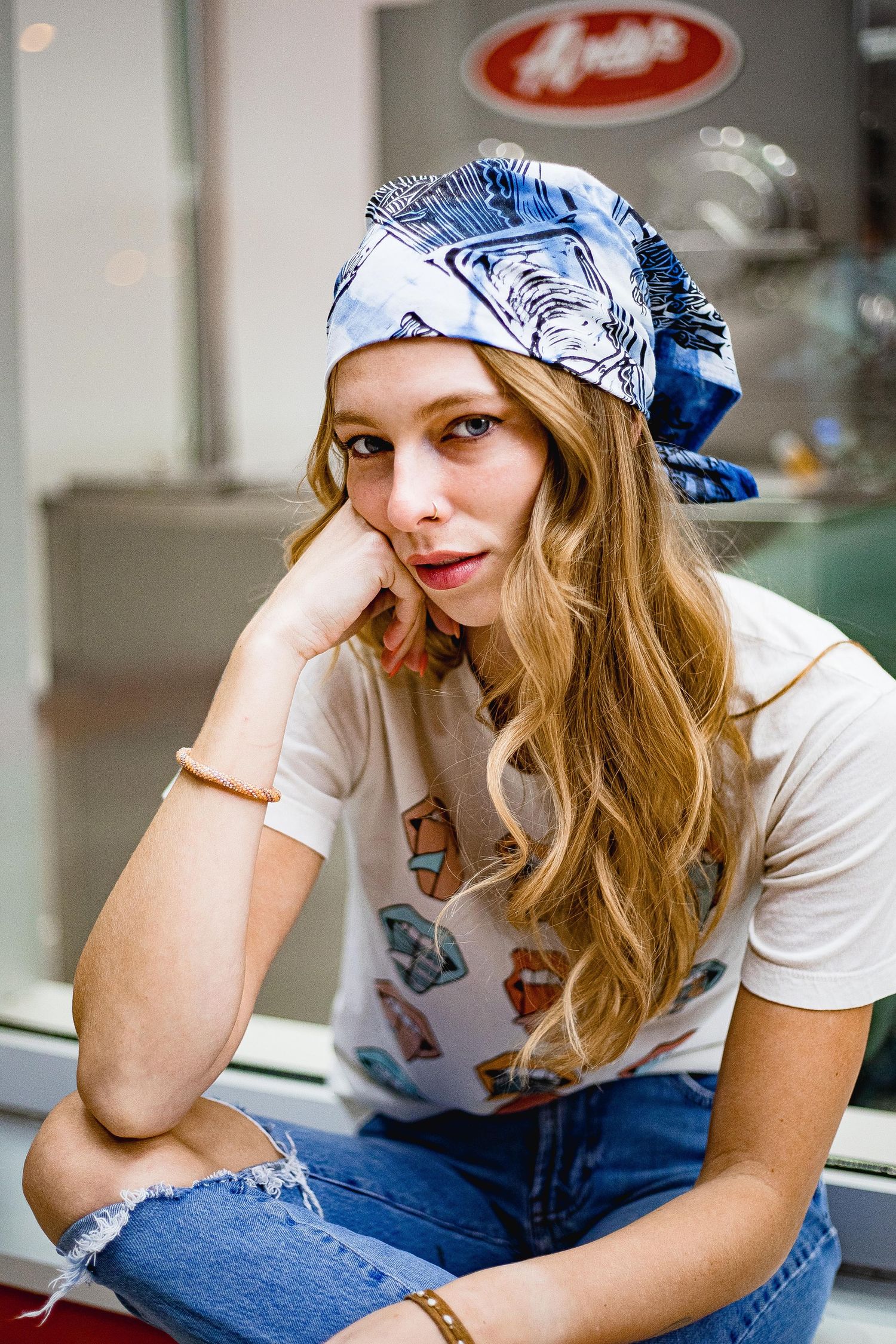 Blonde surfer girl resting head on hand