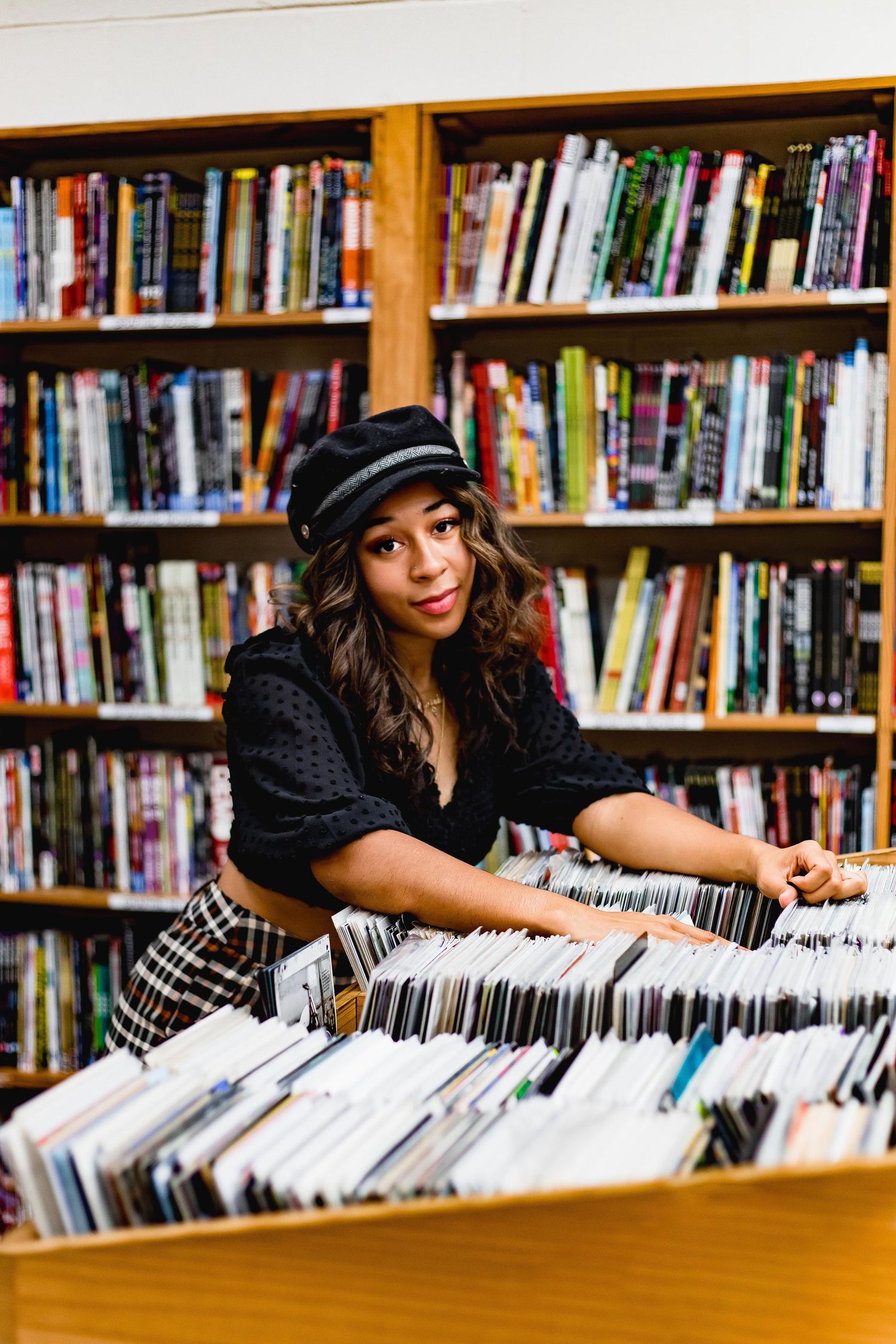Girl going through comic books at book store