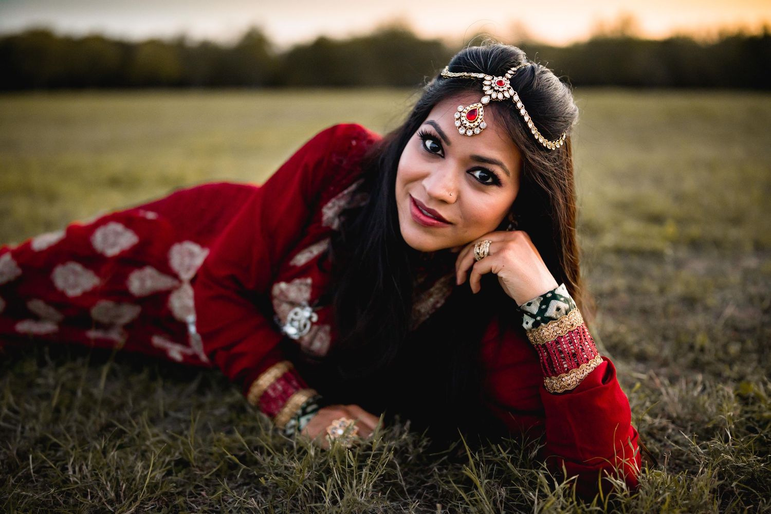Bollywood inspired, woman laying on grass in traditional India dress