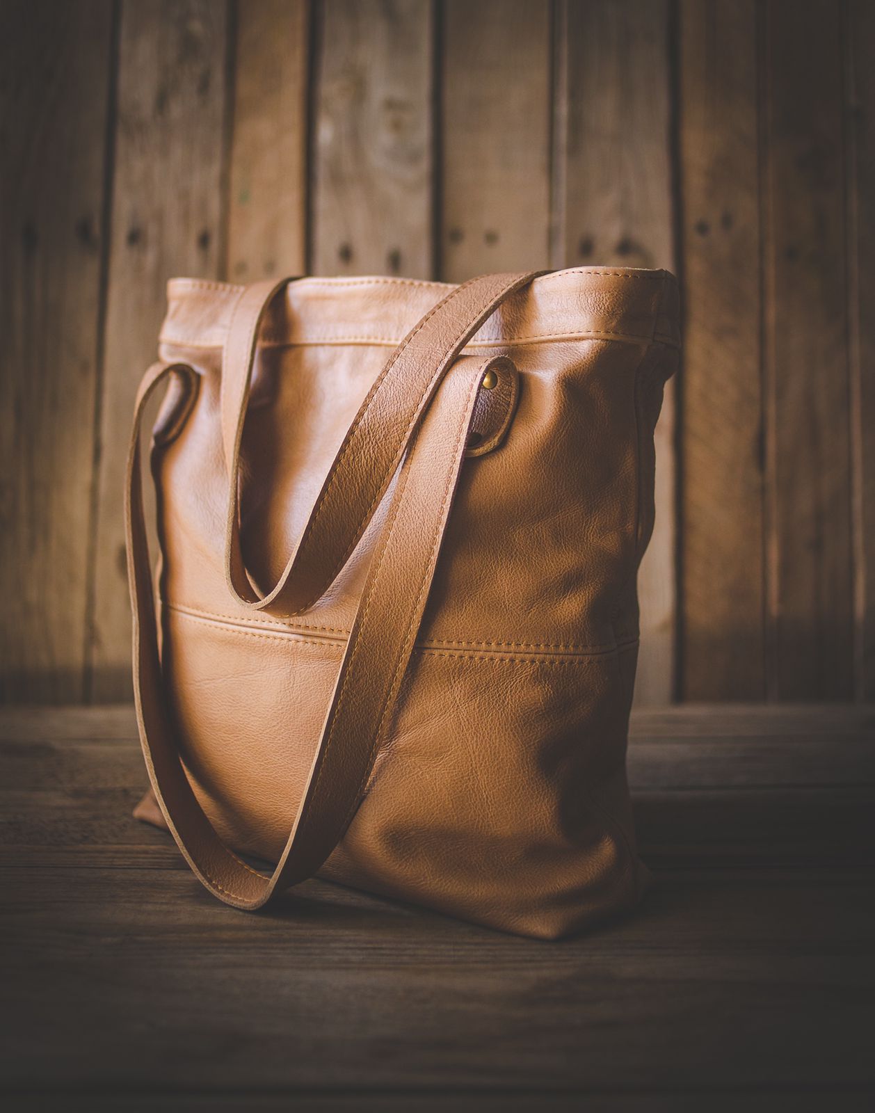 leather tote handbag on wooden background for love and leather