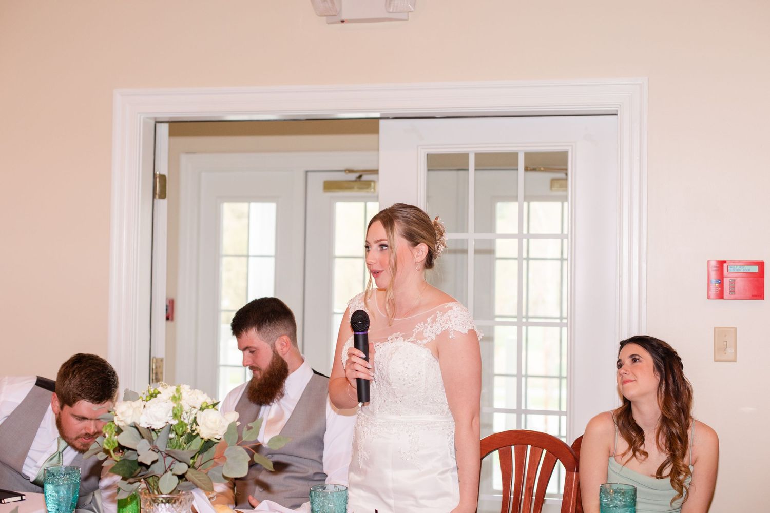Wedding reception venue with white trim doorways and peach colored walls.