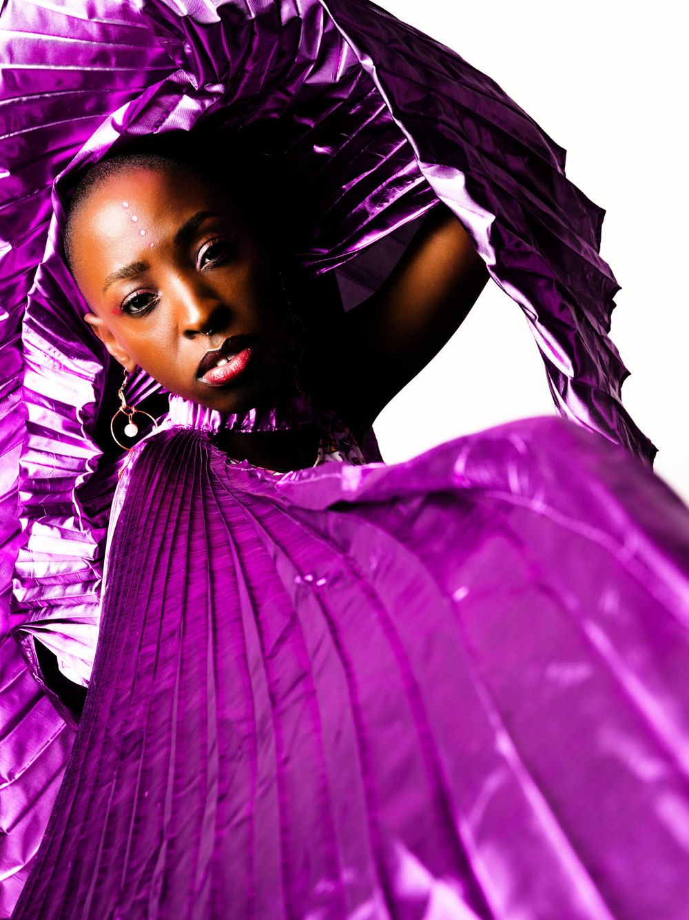Dynamic fashion photo series featuring flowing purple fabric against white background.