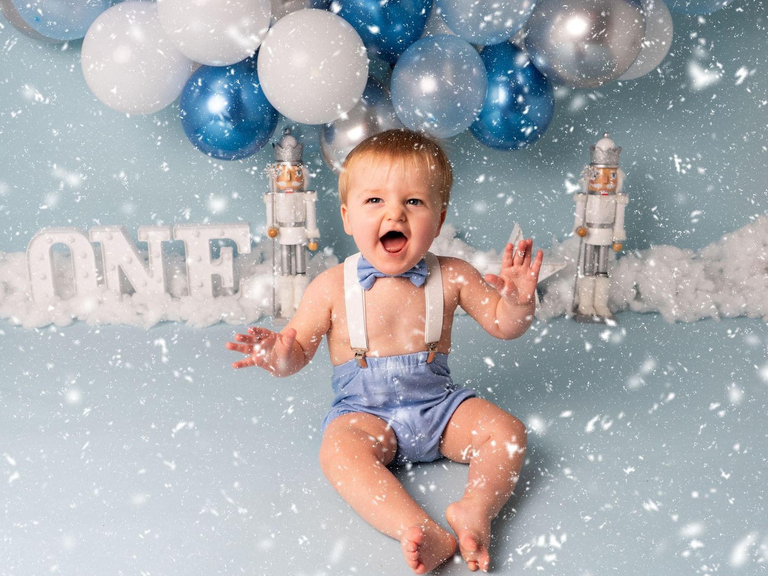 first birthday cake smash for one year old smiling on snowy winter sceen by client of heather katie photography.