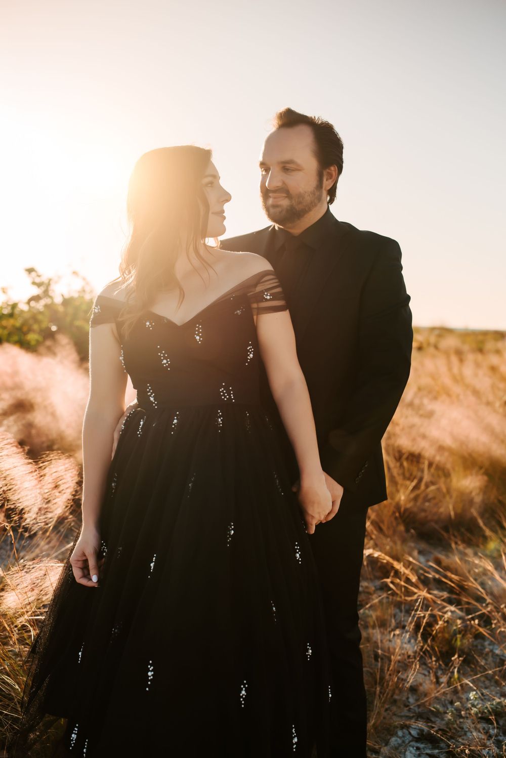 Man and woman look at each other after getting married outdoors.