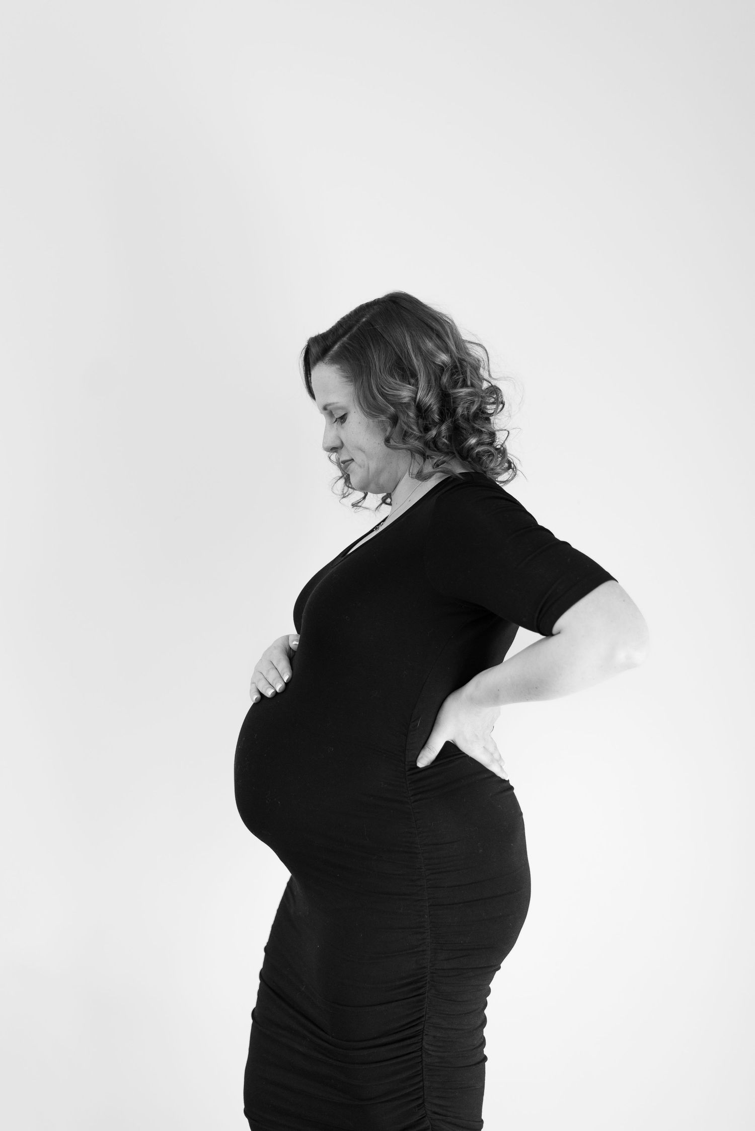 A series of black and white profile shots showing a pregnant silhouette against white background.
