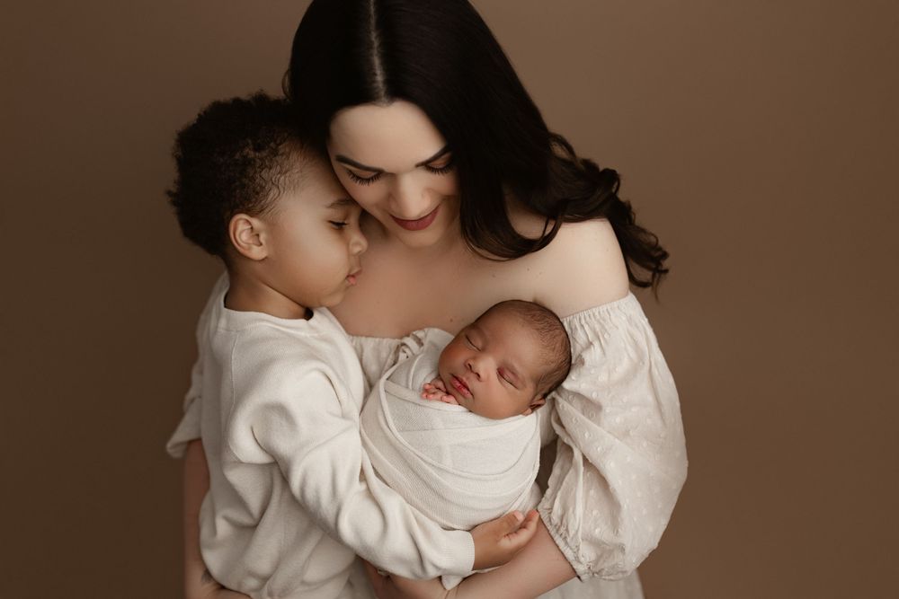 A heartwarming portrait showing family bonding with newborn in neutral tones.